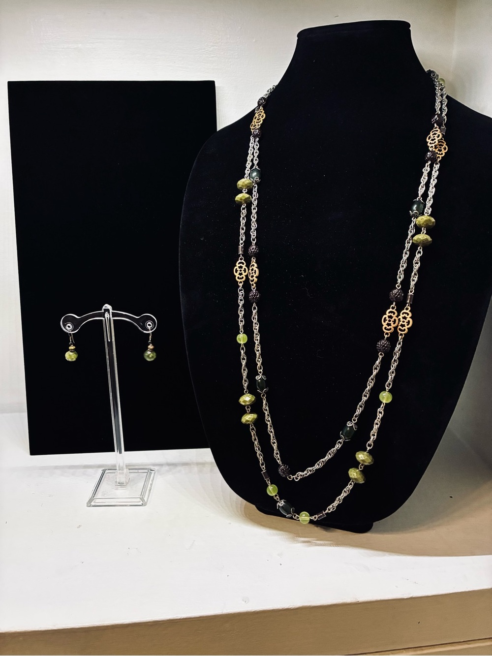 Long multi-layered beaded chain necklace and a pair of matching drop earrings.